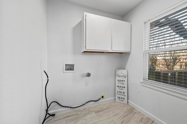 washroom with cabinets, electric dryer hookup, and hookup for a washing machine