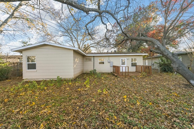 rear view of property featuring a deck