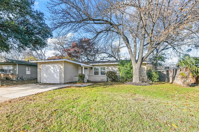 ranch-style house featuring a garage and a front lawn