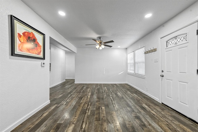 foyer with a textured ceiling, dark hardwood / wood-style floors, and ceiling fan