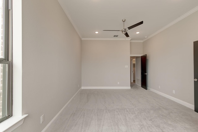 carpeted empty room with crown molding and ceiling fan