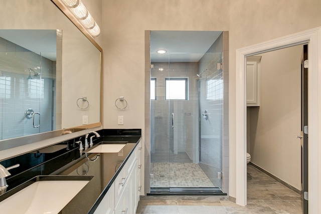 bathroom featuring vanity, toilet, and an enclosed shower