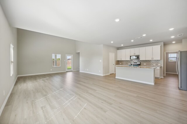 unfurnished living room with light wood-type flooring