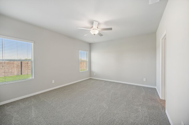 carpeted empty room featuring ceiling fan