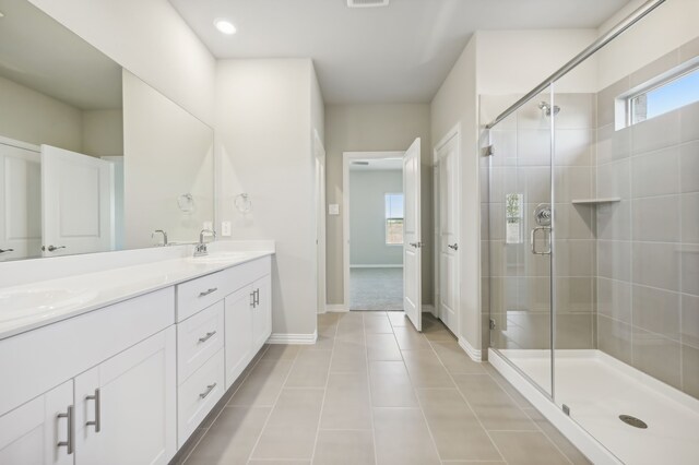 bathroom featuring tile patterned flooring, vanity, and an enclosed shower