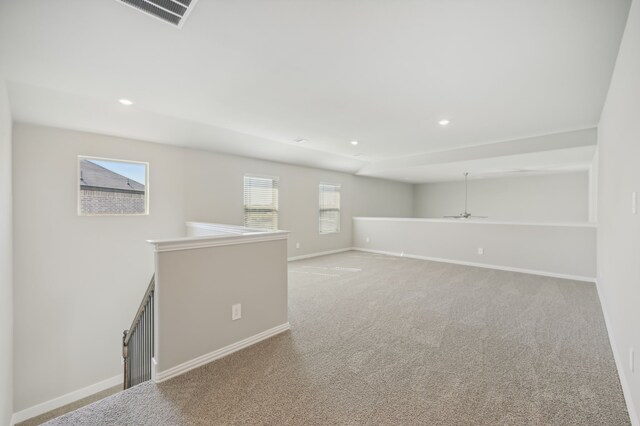 unfurnished room with light carpet and ceiling fan