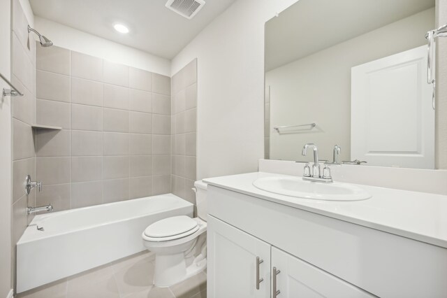 full bathroom with tile patterned floors, vanity, toilet, and tiled shower / bath