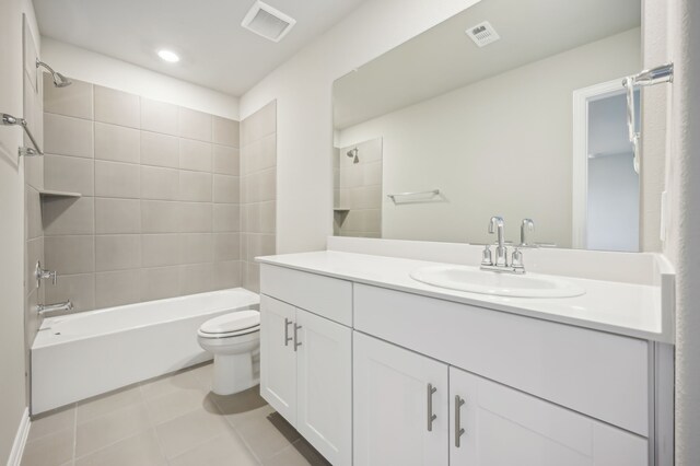 full bathroom with vanity, tiled shower / bath combo, and toilet