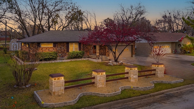 view of front facade with a yard and a garage