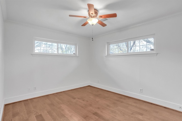 unfurnished room with light hardwood / wood-style floors, a wealth of natural light, and crown molding