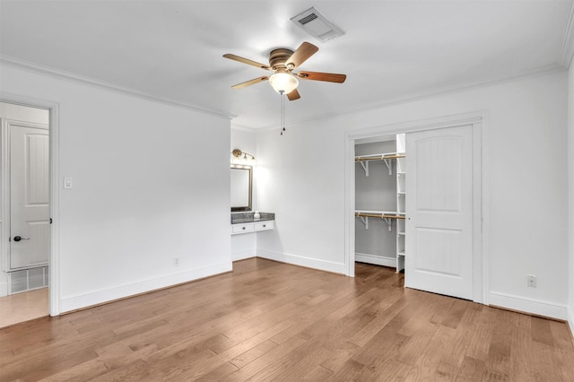 unfurnished living room featuring crown molding, ceiling fan, and light wood-type flooring