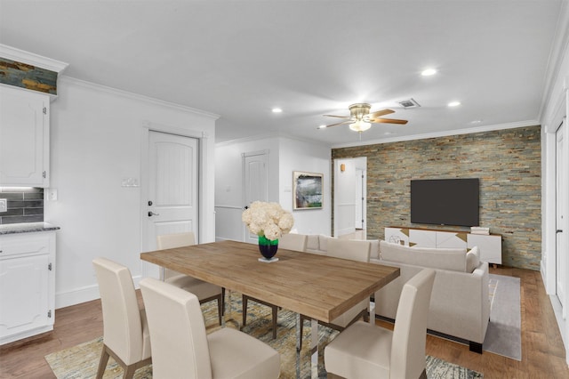 dining area with hardwood / wood-style floors, ceiling fan, and crown molding