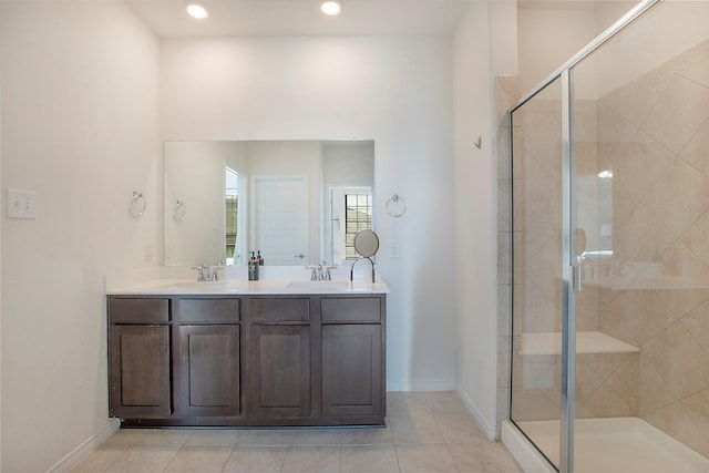 bathroom featuring tile patterned flooring, vanity, and a shower with shower door