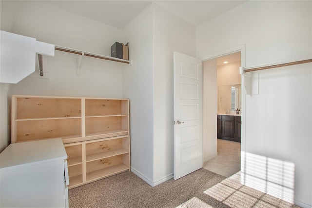 spacious closet featuring light carpet