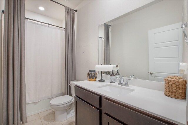 full bathroom with toilet, shower / tub combo, vanity, and tile patterned floors