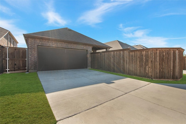 exterior space featuring a garage and a lawn