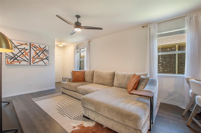 living room with ceiling fan, dark wood-type flooring, and a healthy amount of sunlight