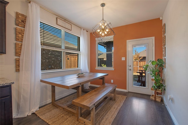 dining area with a chandelier and dark hardwood / wood-style floors