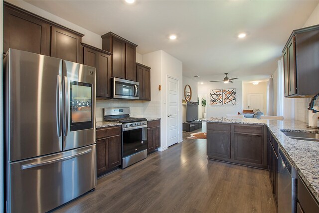 kitchen with sink, stainless steel appliances, tasteful backsplash, and dark hardwood / wood-style floors