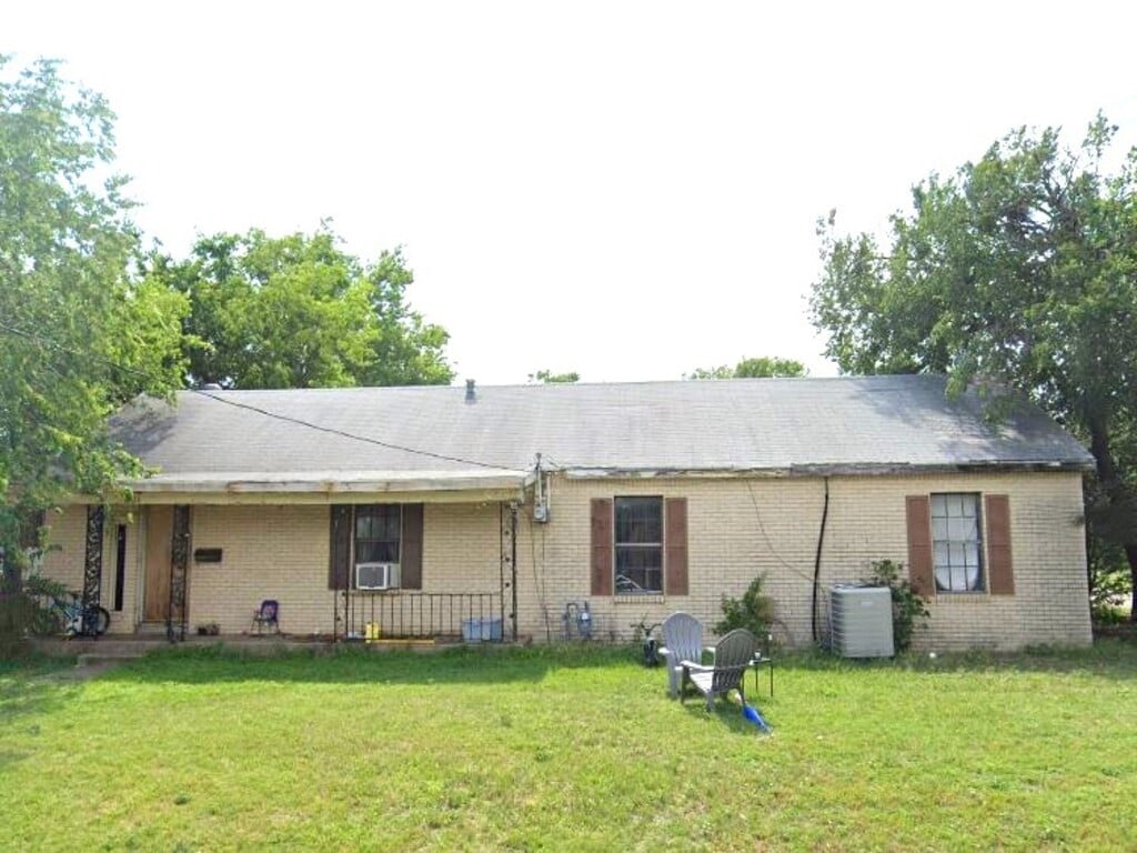 back of house featuring a yard and cooling unit