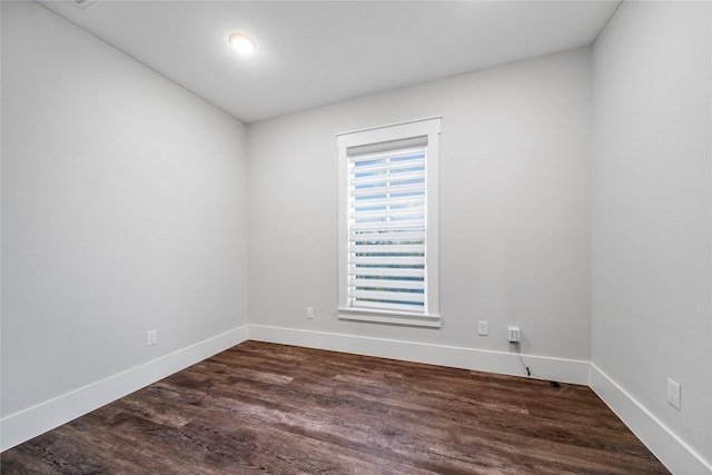 spare room featuring dark hardwood / wood-style flooring