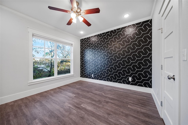 empty room featuring ceiling fan, hardwood / wood-style floors, and ornamental molding