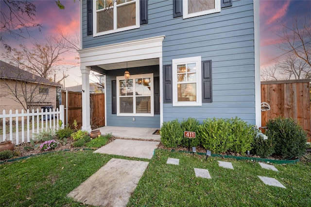 exterior entry at dusk with a yard