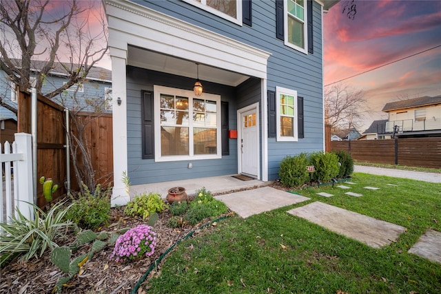 exterior entry at dusk with a lawn