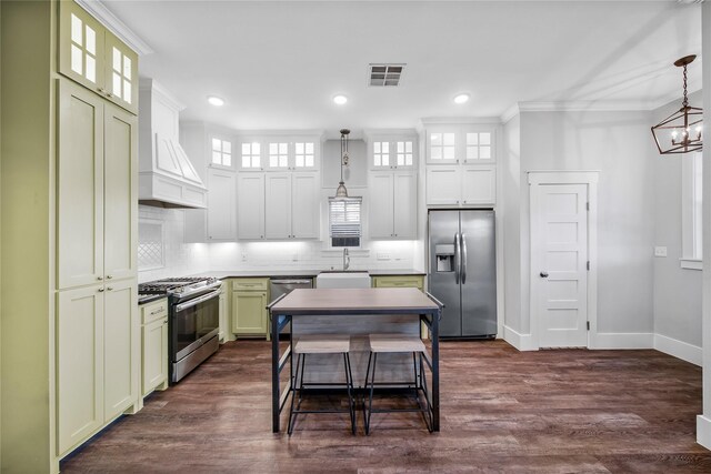 kitchen with custom exhaust hood, a center island, dark wood-type flooring, hanging light fixtures, and appliances with stainless steel finishes