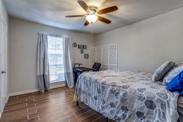 bedroom with a textured ceiling, dark hardwood / wood-style flooring, and ceiling fan