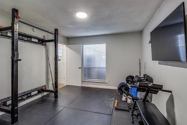 workout area featuring a textured ceiling