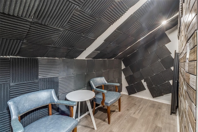 sitting room featuring lofted ceiling and wood-type flooring