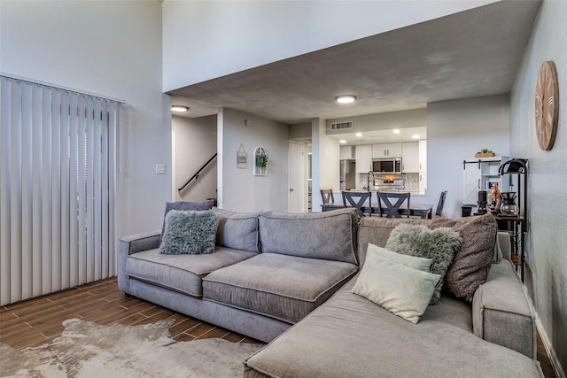 living room featuring dark wood-type flooring