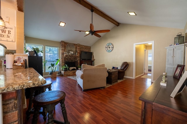 living room featuring dark hardwood / wood-style flooring, beam ceiling, a fireplace, and ceiling fan