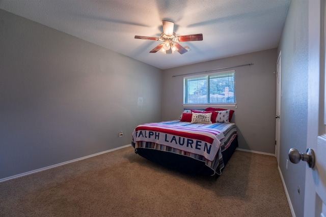 carpeted bedroom with a textured ceiling and ceiling fan