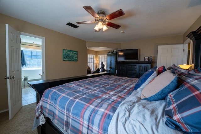 bedroom with multiple windows, light carpet, and ceiling fan