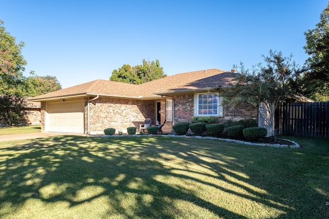 ranch-style house featuring a garage and a front lawn