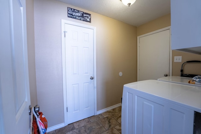 laundry room featuring washer and dryer and a textured ceiling