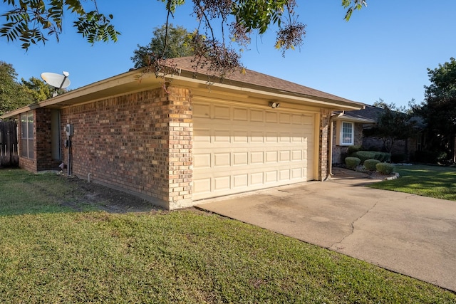 view of side of property with a garage and a lawn