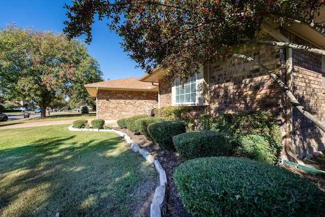 view of side of home featuring a lawn