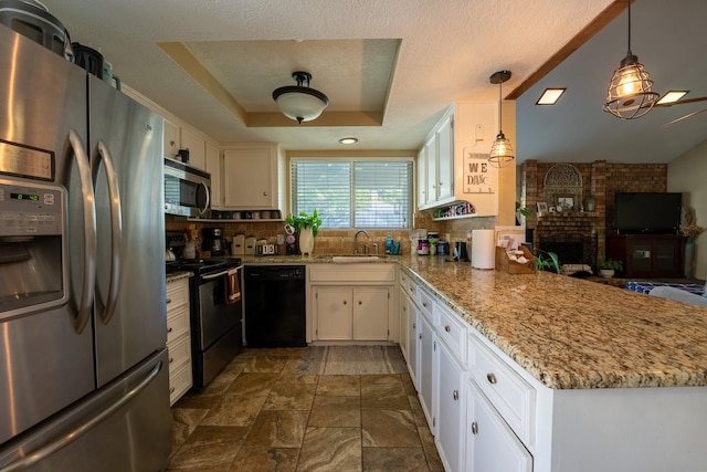 kitchen featuring stainless steel appliances, kitchen peninsula, white cabinets, and decorative light fixtures