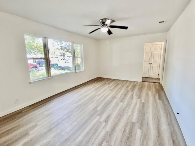 spare room with ceiling fan and light hardwood / wood-style flooring