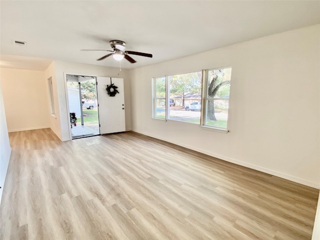 unfurnished room with ceiling fan and light wood-type flooring