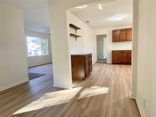 kitchen featuring decorative backsplash and light hardwood / wood-style floors