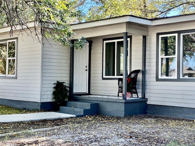 doorway to property featuring covered porch