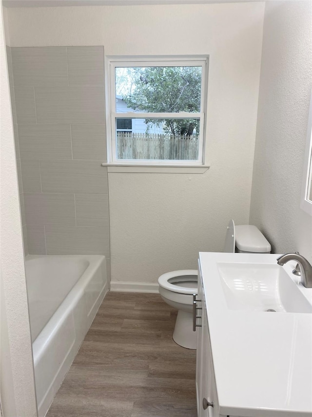 bathroom with vanity, wood-type flooring, and toilet