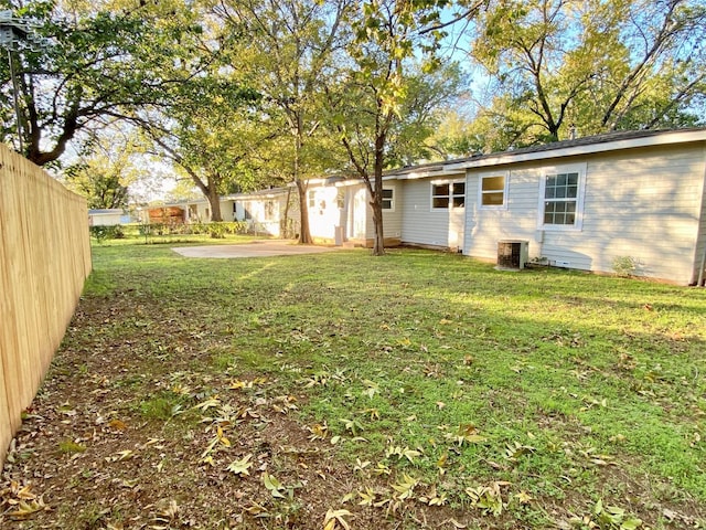 view of yard featuring cooling unit and a patio area