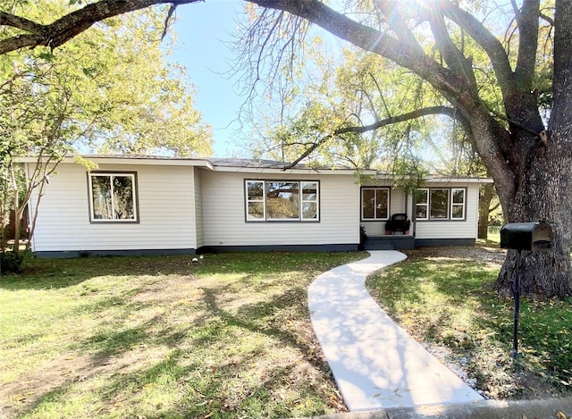 ranch-style home with a front lawn