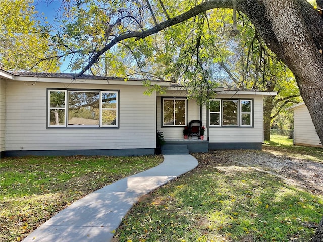 ranch-style home with a front lawn