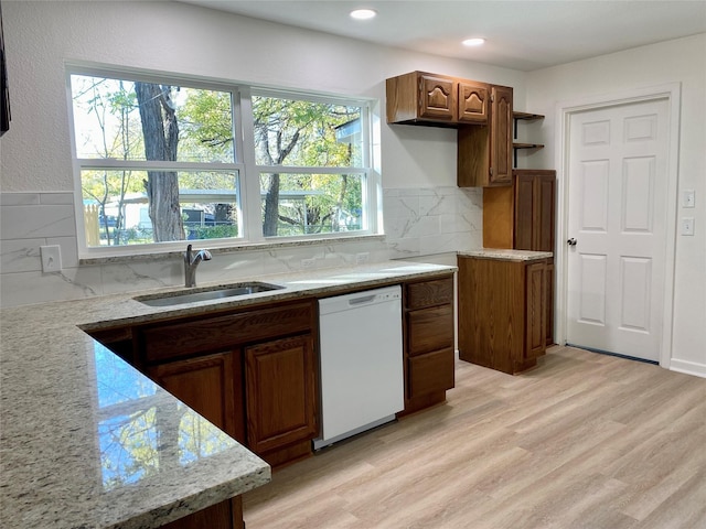 kitchen featuring dishwasher, light wood-type flooring, plenty of natural light, and sink